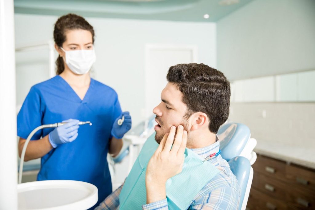 Emergency dentist treating severe tooth pain in Doha dental clinic